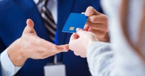 (man handing a woman a credit card)