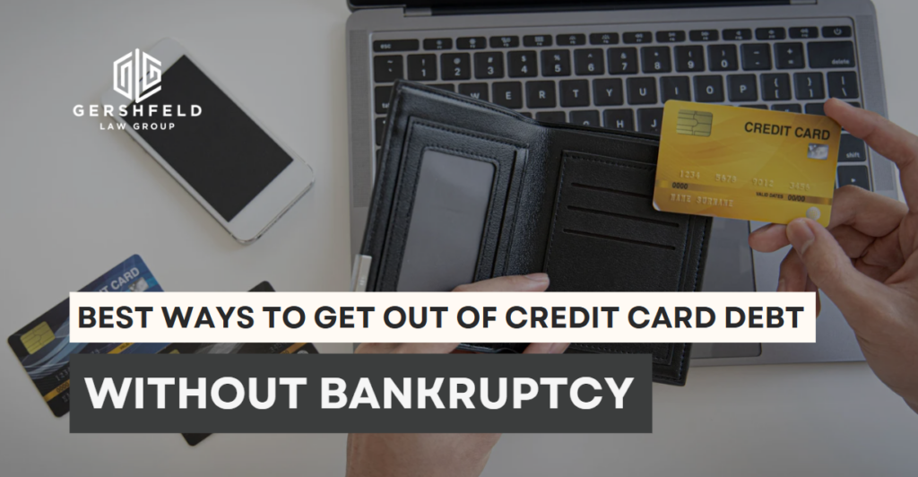 Person holding a credit card over an empty wallet and laptop, representing the struggle with debt and the search for non-bankruptcy solutions.