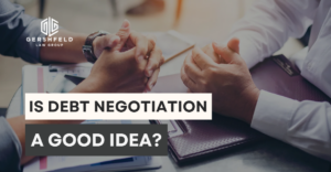Two individuals sit across a desk discussing financial documents, with the text "Is Debt Negotiation a Good Idea?" overlaid—representing legal or financial consultation with Gershfeld Law Group.