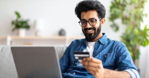 “person enjoying debt free living checking bank account”)