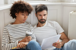 Couple reviewing legal paperwork at home.